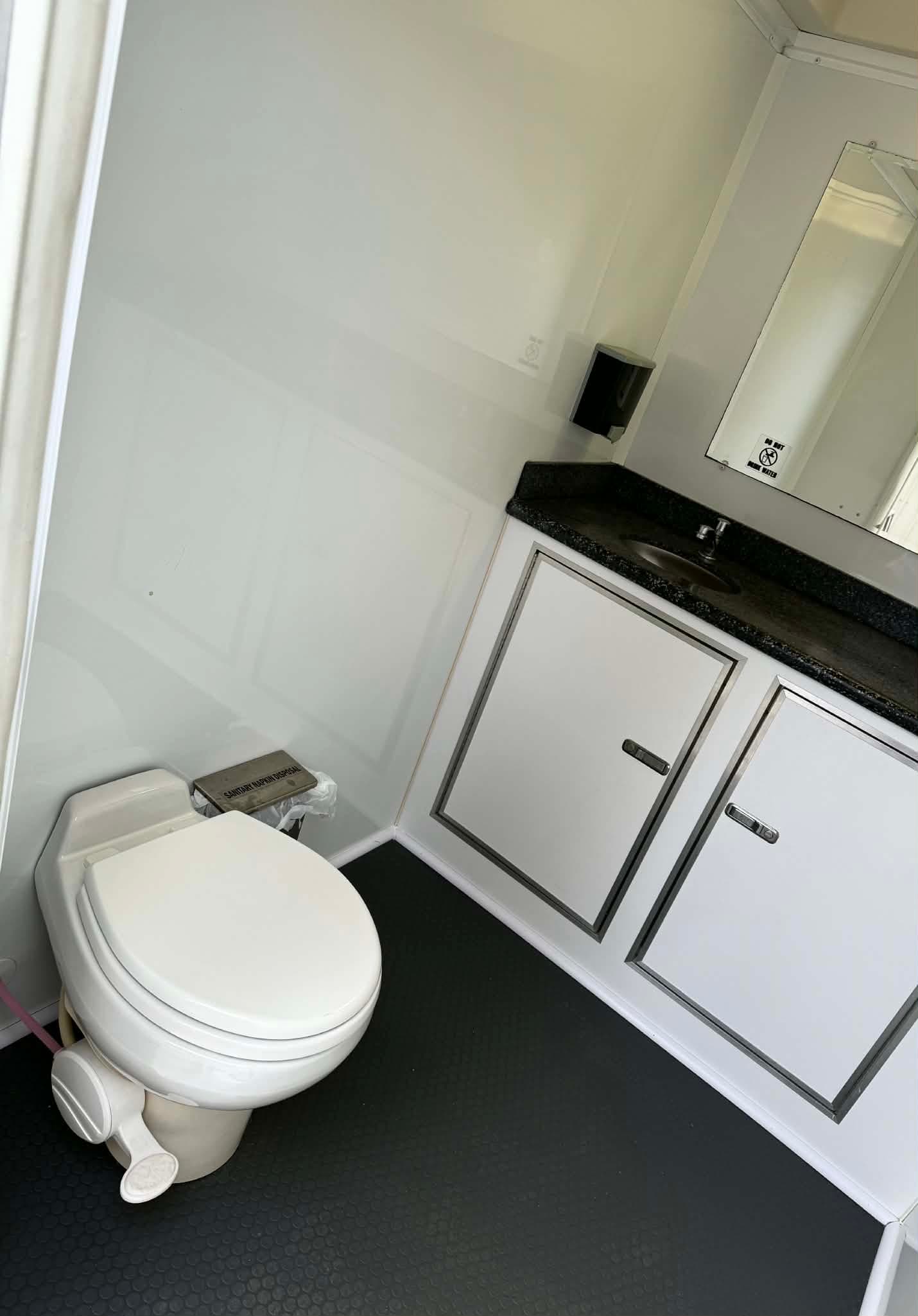 Two-stall interior vanity and toilet view